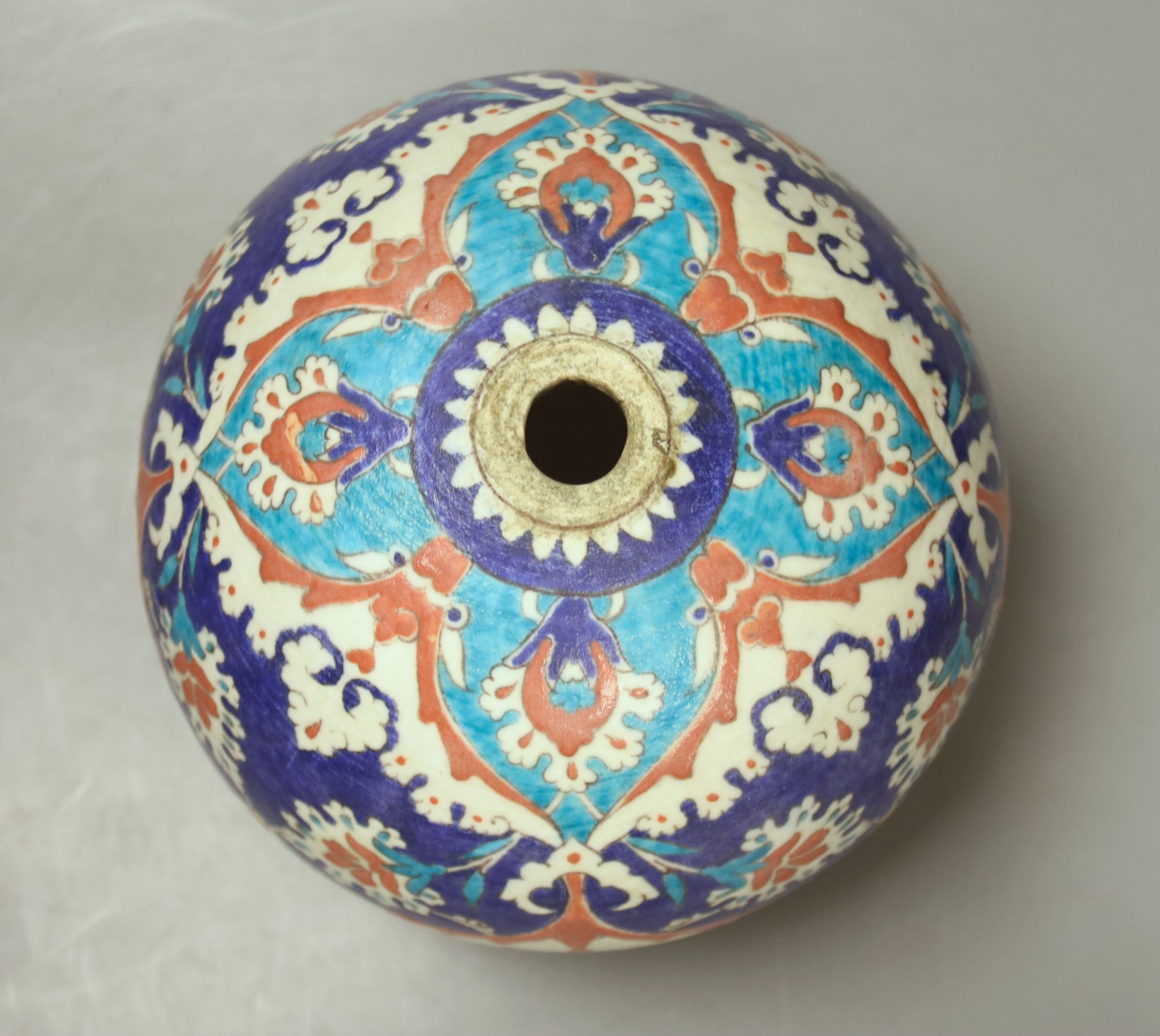 A Turkish Ottoman earthenware hanging mosque bowl, Isnik design, 19cm high
